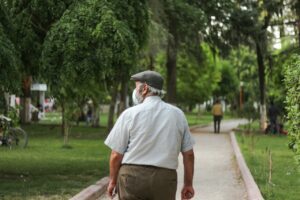 senior man taking a walk through a park