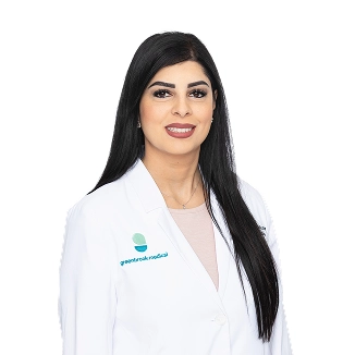 Dr. Sarah Khan, a physician at Greenbrook Medical, wearing a white lab coat.