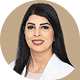 Dr. Shereen Naccour, a medical professional in a white lab coat