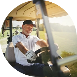 Man driving a golf cart on a sunny day
