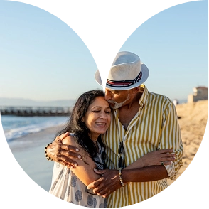 Loving senior couple embracing on a beach at sunset
