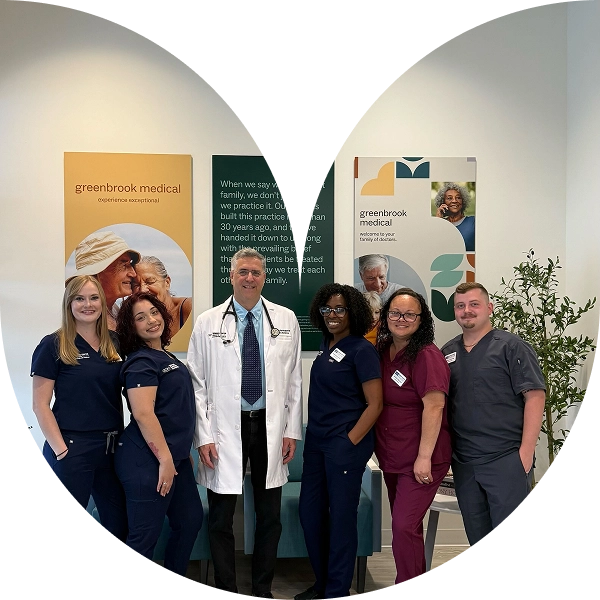 Greenbrook Medical team: doctor in white coat with nurses in scrubs